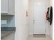 Hallway with a tiled floor, neutral decor, and a white door at 10127 Newel Valley Loop, Riverview, FL 33569