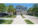 Charming townhome with a two-car garage, palm trees, and well-maintained landscaping at 10127 Newel Valley Loop, Riverview, FL 33569