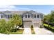 Charming home exterior with a two-car garage, landscaped yard and a light gray facade at 10127 Newel Valley Loop, Riverview, FL 33569
