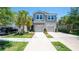 Charming townhome with a two-car garage, palm trees, and well-maintained landscaping at 10127 Newel Valley Loop, Riverview, FL 33569