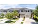 Attractive home exterior featuring a two-car garage, palm trees, and well-kept landscaping at 10127 Newel Valley Loop, Riverview, FL 33569