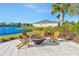 Relaxing outdoor firepit area with chairs overlooking a scenic lake in the neighborhood at 10127 Newel Valley Loop, Riverview, FL 33569
