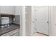 Hallway with tiled floors, storage, and a white door at 10127 Newel Valley Loop, Riverview, FL 33569