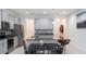 Bright eat-in kitchen boasts an island with bar seating, granite countertops, stainless steel appliances, and light gray cabinetry at 10127 Newel Valley Loop, Riverview, FL 33569