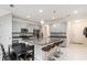 Bright eat-in kitchen boasts an island with bar seating, granite countertops, stainless steel appliances, and light gray cabinetry at 10127 Newel Valley Loop, Riverview, FL 33569