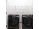 Laundry room with front loading washer and dryer and metal shelf at 10127 Newel Valley Loop, Riverview, FL 33569