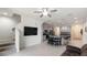 Open concept living room features a ceiling fan, stairs, and flows into the kitchen and dining area at 10127 Newel Valley Loop, Riverview, FL 33569