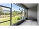 Screened-in patio area with view of the manicured backyard and green space at 10127 Newel Valley Loop, Riverview, FL 33569