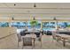 Outdoor lounge and seating area with multiple tables overlooking community swimming pools at 10127 Newel Valley Loop, Riverview, FL 33569