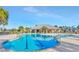 Beautiful community pool with lounge chairs and covered area under a clear blue sky at 10127 Newel Valley Loop, Riverview, FL 33569