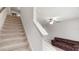 Carpeted stairs with white railing lead to the second floor at 10127 Newel Valley Loop, Riverview, FL 33569