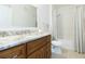 Bright bathroom featuring granite countertop, wooden cabinetry, and a shower-tub combination at 10502 Villa View Cir, Tampa, FL 33647