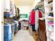 Walk-in closet featuring ample storage shelves, clothes rods, and boxes, maximizing space and organization at 10502 Villa View Cir, Tampa, FL 33647