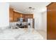 Kitchen featuring wood cabinets, stainless steel appliances, granite countertops, and tile floors at 10502 Villa View Cir, Tampa, FL 33647