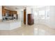 Open layout shows the kitchen, dining area with chandelier, and decorative cabinet at 10502 Villa View Cir, Tampa, FL 33647