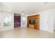 Spacious living room with tile flooring, built-in wooden shelves and built in bar at 10502 Villa View Cir, Tampa, FL 33647