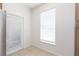 Bright mud room with tile floor, door to outside, and a window at 10502 Villa View Cir, Tampa, FL 33647