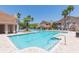 Community pool with lounge chairs and lush tropical landscaping at 10502 Villa View Cir, Tampa, FL 33647