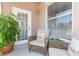 Cozy screened porch, furnished with comfortable seating for relaxing and enjoying the outdoors at 10502 Villa View Cir, Tampa, FL 33647