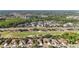 An aerial view showcases a golf course community with serene lakes and lush landscapes at 10517 Palm Cove Ave, Tampa, FL 33647