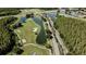 Aerial view of a golf course community with ponds, manicured fairways, and lush trees at 10517 Palm Cove Ave, Tampa, FL 33647