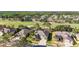Aerial view showcasing a neighborhood with well-maintained homes, lush landscaping, and scenic views of the golf course at 10517 Palm Cove Ave, Tampa, FL 33647