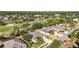 Aerial view displaying a community with homes, a golf course, and scenic views of trees and landscape at 10517 Palm Cove Ave, Tampa, FL 33647