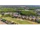 This aerial view showcases a golf course community with lush trees and tranquil ponds at 10517 Palm Cove Ave, Tampa, FL 33647