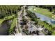 Aerial view of a lush community entrance with palm trees, water features, and golf course at 10517 Palm Cove Ave, Tampa, FL 33647