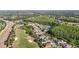This aerial view highlights a neighborhood adjacent to a golf course and natural ponds at 10517 Palm Cove Ave, Tampa, FL 33647