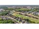 This aerial captures a beautiful community near a golf course, lakes, and green landscape at 10517 Palm Cove Ave, Tampa, FL 33647