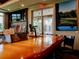 Close-up of the bar area featuring a wooden counter, various drink options, and a television screen at 10517 Palm Cove Ave, Tampa, FL 33647