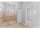 Accessible bathroom featuring a tiled roll-in shower and neutral-colored tile flooring at 10517 Palm Cove Ave, Tampa, FL 33647
