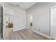 Neutral bedroom with wood-look floors, closet, and an ensuite bathroom doorway at 10517 Palm Cove Ave, Tampa, FL 33647
