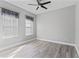A bright bedroom boasts hard surface floors and large windows at 10517 Palm Cove Ave, Tampa, FL 33647