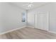 Bright bedroom with wood-look floors, a ceiling fan, and a spacious closet at 10517 Palm Cove Ave, Tampa, FL 33647