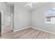 Neutral bedroom with wood-look floors, ceiling fan, and plenty of natural light at 10517 Palm Cove Ave, Tampa, FL 33647