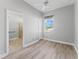 Bright bedroom with a ceiling fan, a walk-in closet, and an ensuite bathroom, offering comfort and convenience at 10517 Palm Cove Ave, Tampa, FL 33647
