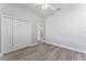 Bedroom with a ceiling fan, closet, wood-look floors, and neutral walls at 10517 Palm Cove Ave, Tampa, FL 33647