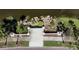 Aerial view of the formal entrance to the community with sidewalks and professional landscaping at 10517 Palm Cove Ave, Tampa, FL 33647