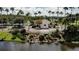 Aerial view of a community entrance with a waterfall feature and lush landscaping surrounded by a scenic lake at 10517 Palm Cove Ave, Tampa, FL 33647