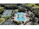 Aerial view of a resort-style pool area with slides, lap lanes, and tennis courts at 10517 Palm Cove Ave, Tampa, FL 33647