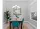 Bright dining room with a chandelier, large window, and hardwood table at 10517 Palm Cove Ave, Tampa, FL 33647