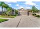Charming home with well-manicured landscaping, a spacious driveway, and a three-car garage for ample parking at 10517 Palm Cove Ave, Tampa, FL 33647