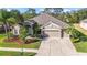 Beautiful home with lush landscaping, a wide driveway, and a three-car garage, providing both curb appeal and convenience at 10517 Palm Cove Ave, Tampa, FL 33647