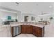 Open-concept kitchen with stainless steel appliances and views of the living area at 10517 Palm Cove Ave, Tampa, FL 33647