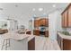 Well-lit kitchen showcases stainless steel appliances, wooden cabinets and an island at 10517 Palm Cove Ave, Tampa, FL 33647