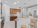 Bright kitchen features wood cabinets, breakfast bar with stools, and recessed lighting at 10517 Palm Cove Ave, Tampa, FL 33647