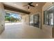 Enclosed lanai with ceiling fan, textured walls, and exterior view to the lawn and trees at 10517 Palm Cove Ave, Tampa, FL 33647