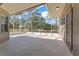 Screened-in lanai with view of the green yard, trees, and open sky at 10517 Palm Cove Ave, Tampa, FL 33647